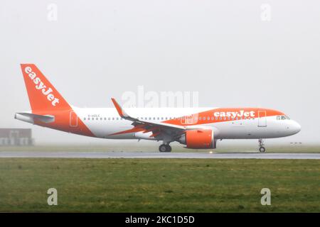 An EasyJet low-cost airline Airbus A320neo new advanced airplane as seen landing at Amsterdam AMS EHAM Schiphol International Airport in the Netherlands on April 13, 2020, during a bad weather windy with rain, mist, fog and haze day. The aircraft has the registration G-UZLC. EasyJet U2 is a British budget carrier based in London, flying in more than 30 countries. On March 30, 2020 the airline grounded its entire fleet of planes and closed three bases because of Covid-19 coronavirus pandemic. (Photo by Nicolas Economou/NurPhoto) Stock Photo