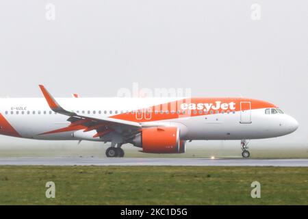 An EasyJet low-cost airline Airbus A320neo new advanced airplane as seen landing at Amsterdam AMS EHAM Schiphol International Airport in the Netherlands on April 13, 2020, during a bad weather windy with rain, mist, fog and haze day. The aircraft has the registration G-UZLC. EasyJet U2 is a British budget carrier based in London, flying in more than 30 countries. On March 30, 2020 the airline grounded its entire fleet of planes and closed three bases because of Covid-19 coronavirus pandemic. (Photo by Nicolas Economou/NurPhoto) Stock Photo