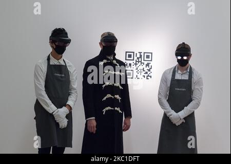 Staff members look at mixed reality installation 'The Life' (2018-2019) by Marina Abramovic (est. £400,000-800,000) through the VR headsets during a photo call for 20th Century: London to Paris sale series at Christie's on October 09, 2020 in London, England. The new sale series, jointly presented by Christie’s London and Christie’s Paris, celebrating the best in Impressionist, modern, post-war and contemporary art and design will take place on 22 and 23 October. (Photo by WIktor Szymanowicz/NurPhoto) Stock Photo