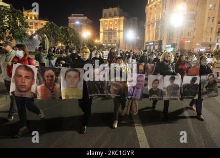 Relatives and friends carry portraits of Ukrainian prisoners, held in eastern Ukraine regions controlled by pro-Russian separatists, during all-Ukrainian action 'Remind about everyone' in support of prisoners and relatives of the missing in downtown of Kyiv, Ukraine on 10 October 2020. Hundreds of people, relatives of detainees and missing persons, former prisoners, and supporters held their march rally demand the adoption of a law on captive prisoners and a law on war crimes. (Photo by STR/NurPhoto) Stock Photo