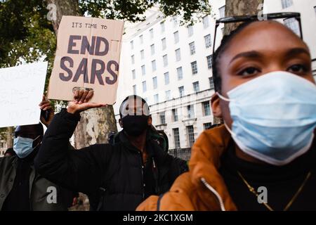 Activists protesting police brutality by the Nigerian Special Anti-Robbery Squad (SARS) demonstrate on Whitehall in London, England, on October 15, 2020. SARS has been accused of extrajudicial killings, extortion and torture, prompting demonstrations across Nigeria in the past week that have continued despite authorities there now agreeing to disband the unit, which is to be replaced by a Special Weapons and Tactics (SWAT) team. (Photo by David Cliff/NurPhoto) Stock Photo