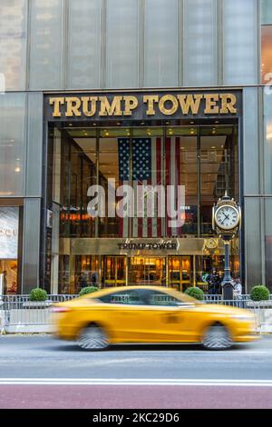 A NY taxi is passing in front of the main entrance of Trump Tower with the inscription on it and a US flag. Trump Tower in New York city in the USA. The 58-floor skyscraper at Fifth Avenue in Midtown Manhattan hosts the headquarters for Trump Organization and houses the penthouse condominium residence of US President Donald Trump, who is also a businessman and real estate developer. The building was designed by Der Scutt in modernism architecture with glass and stepped facade at the building, construction began in 1979 in NYC. New York, USA on February 2020 (Photo by Nicolas Economou/NurPhoto) Stock Photo