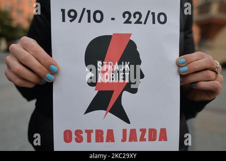 Pro-Choice activist with a logo of the 'Women Strike', seen in the center of Krakow, part of the Coronavirus Red Zone, during a protest against a proposed law that prohibits abortion for irreversible damage to the fetus. Tomorrow, on Thursday, October 22, the Constitutional Tribunal is to consider the motion of a group of PiS (Law and Justice rulling party) deputies regarding the constitutionality of the so-called Eugenic abortion, performed in case of suspicion of a child's disease or its impairment. A group of PiS MPs submitted an application to the Constitutional Tribunal. On October 21, 20 Stock Photo