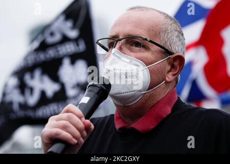 Chris Whitehouse, chairman of the Whitehouse Consultancy and secretary to the All-Party Parliamentary Group on Hong Kong addresses a 'Save 12 HK Youths' rally featuring prominent Hong Kong exile Nathan Law at Potters Fields Park beside Tower Bridge in London, England, on October 24, 2020. The 'Save 12 HK Youths' campaign calls for the release of 12 young pro-democracy activists held since August in mainland China having been caught trying to flee Hong Kong by boat, reportedly for Taiwan. Today's London rally marks Law's first public appearance since he fled to the UK in July, following the int Stock Photo