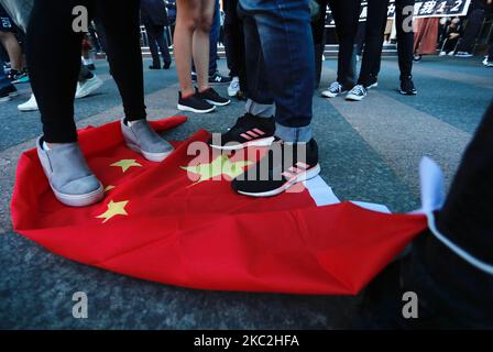 Approximately 3000 people wearing black bloc, holding signs and Hong Kong independence flags and chanting slogans demand for release of the 12 Hong Kong people who have been apprehended by Chinese law enforcement during their trip by boat to Taiwan, in Taipei City, Taiwan, on 25 October 2020. The group stepping onto China's national flags and waving the flags of former British Hong Kong also gather outside the Chinese owned Taipei Branch of ''Bank of China'' before ending the march at the Hong Kong Economic, Trade and Cultural Office in Taipei. (Photo by Ceng Shou Yi/NurPhoto) Stock Photo