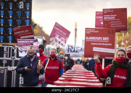 People and employees of the event industry attend a demonstration under the motto Alarmstufe Rot (Alarm level red) to protest against measures considered too hard and damaging of the sector and demand government assistance during the second wave of the coronavirus pandemic on October 28, 2020 in Berlin, Germany. (Photo by Emmanuele Contini/NurPhoto) Stock Photo