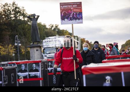 People and employees of the event industry attend a demonstration under the motto Alarmstufe Rot (Alarm level red) to protest against measures considered too hard and damaging of the sector and demand government assistance during the second wave of the coronavirus pandemic on October 28, 2020 in Berlin, Germany. (Photo by Emmanuele Contini/NurPhoto) Stock Photo