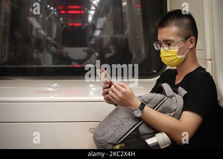 Passengers wear surgical masks during their rides on public transports including buses and trains, as Taiwan has passed 200 days with no local infections of the pandemic disease COVID-19, in Taipei City, Taiwan, on 29 October 2020. The authority of the island has made wearing masks when staying within certain indoor areas compulsory in face of the global rising number of infections. (Photo by Ceng Shou Yi/NurPhoto) Stock Photo