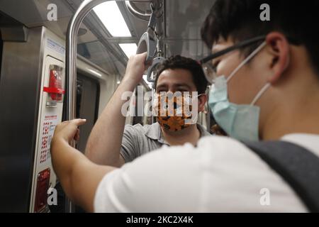 Passengers wear surgical masks during their rides on public transports including buses and trains, as Taiwan has passed 200 days with no local infections of the pandemic disease COVID-19, in Taipei City, Taiwan, on 29 October 2020. The authority of the island has made wearing masks when staying within certain indoor areas compulsory in face of the global rising number of infections. (Photo by Ceng Shou Yi/NurPhoto) Stock Photo