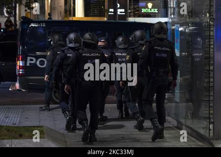 A group of anti-riot police goes to the van to patrol the streets of Santander, Spain, on October 31, 2020 before the warning of possible disturbances by radical groups against the curfew imposed by the government to control the contagion of Covid-19 (Photo by Joaquin Gomez Sastre/NurPhoto) Stock Photo