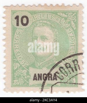 ANGRA - 1897: An 10 reis yellow-green postage stamp showing portrait of Dom Carlos I, known as the Diplomat, the Martyr, and the Oceanographer, among many other names, was the King of Portugal from 1889 until his assassination in 1908 Stock Photo