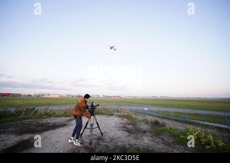 A cameraman films a LOT airliner taking off from Chopin International Airport in Warsaw, Poland on November 5, 2020. The Polish government has approved the first stages of the Solidarity Transport Hub, an air, road and rail hub that will replace the current Chopin Airport as the country's main airport. The initial round of investments amount to close to three billion Euros, two billion of which will be funded by the EU. (Photo by Jaap Arriens/NurPhoto) Stock Photo