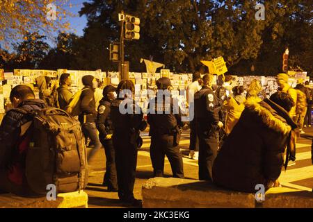 Police officers watch the crowd grow and dwindle as the night went on with no winner in the election announced officially. On November 4, 2020 in Washington DC, US. (Photo by Shay Horse/NurPhoto) Stock Photo