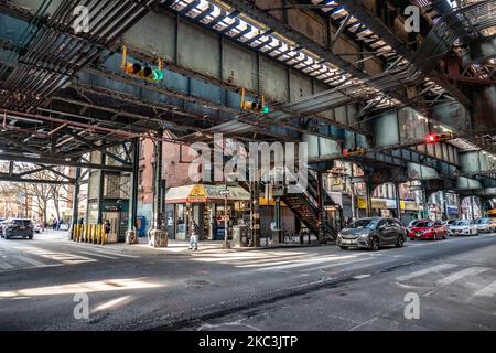 Daily life view of the road and street under the subway railroad air-bridge metal construction of M, J and Z lines near Marcy Ave station, with restaurants, shops, the famous dollar slice pizza, traffic with cars and trucks and with sidewalks in Broadway street in Brooklyn, New York City. Brooklyn is the most populous county in the state of New York and the second-most densely populated in the United States. Brooklyn, NY, USA on 13 February 2020. (Photo by Nicolas Economou/NurPhoto) Stock Photo