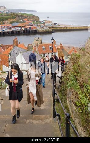 People walking up the 199 steps to the church above Whitby harbour Stock Photo