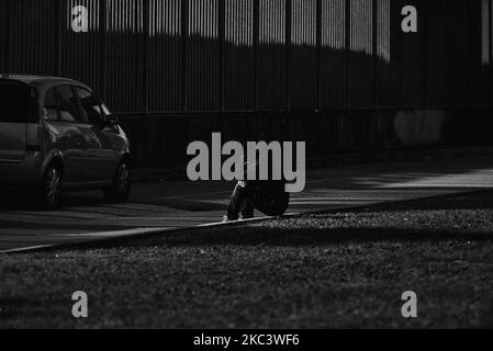 (EDITOR'S NOTE: Image was converted to black and white) a person of Asian origin sitting at the edge of the road that runs along the buffer area set up below the Euganean stadium waits to collect the result of the tampon. Padua, November 11, 2020, italy With the increase in the curve of infections and consequently of the infected, the hospitals of the Veneto and specifically of Padua and Schiavonia are close to collapse. To ease the grueling workload on the shoulders of doctors and nurses, the army took to the field with its qualified personnel. Army doctors and nurses from today preside and h Stock Photo