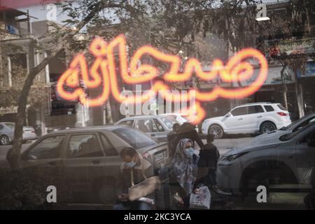 An Iranian man and a woman wearing protective face masks sit on a street-side in the holy city of Mashhad in Razavi Khorasan province 891Km (554 miles) east of Tehran on November 10, 2020, Amid the new coronavirus disease (COVID-19) outbreak in Iran. After Iranian Governments re-announced red alarm in the Iranian holy city of Mashhad and the capital of Khorasan Razavi province, the use of masks in public places became mandatory. (Photo by Morteza Nikoubazl/NurPhoto) Stock Photo