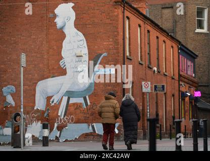 A couple walks by a mural in the center of Dublin. On Saturday, November 14, 2020, in Dublin, Ireland. (Photo by Artur Widak/NurPhoto) Stock Photo