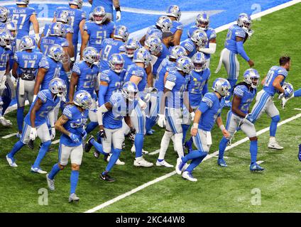 Players on the Washington Football Team run on the field ahead of the first  half of an NFL football game between the Washington Football Team and the  Detroit Lions in Detroit, Michigan