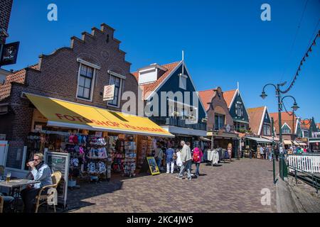 Daily life in Volendam traditional fishing village with Dutch architecture in North Holland near Amsterdam in The Netherlands. Volendam has a harbor and is a popular destination and tourist attraction in the country. There are old fishing boats, traditional clothing of locals, ferry ride to Marken, museums, cheese factroy, cafe and souvenir shops at the waterfront and a little beach. There are houses along the shore and a marina nearby for tourists and locals as visitors so tourism is the main income for the community. Volendam has been featured in many recent movies. Volendam - The Netherland Stock Photo