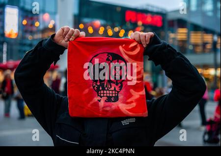 An activist is showing a bib with a skull printed on it, during the 'Circus protest' against Black Friday, in Utrecht, on November 27th, 2020. (Photo by Romy Arroyo Fernandez/NurPhoto) Stock Photo