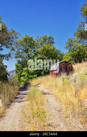 Old abandoned red wood cabin on Hamongog hiking trail below Lone Peak, Wasatch Mountains, Utah. USA. Stock Photo