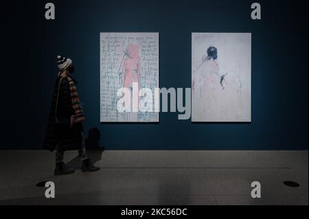 (EDITORIAL USE ONLY) A visitor looks at (L-R) ‘I am the Last of my Kind’ (2019) and ‘You Came’ (2018) by Tracey Emin during a photocall for the Tracey Emin / Edvard Munch: The Loneliness of the Soul exhibition at the Royal Academy of Arts, on December 03, 2020 in London, England. The exhibition features more than 25 of Tracey Emin’s (b.1963) works including paintings, some of which will be on display for the first time, as well neons and sculpture, alongside 19 carefully selected masterpieces by the Norwegian Expressionist Edvard Munch (1863-1944). (Photo by WIktor Szymanowicz/NurPhoto) Stock Photo