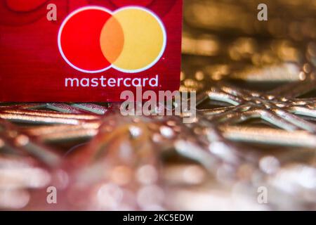 In this photo illustration, a Mastercard seen displayed on top of the 5 ...