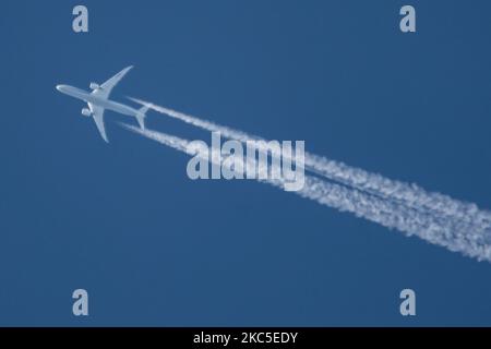 All Nippon Airways Boeing 787 Dreamliner aircraft as seen flying to Paris CDG airport in France in the blue sky over Europe at 40.000 feet leaving the chemtrails or contrails behind, a vapor condensation formation when seen as a white line behind the overfly airplane. The newly made modern and advanced in technology vehicle, built in March 2020 in the USA, long haul overflying airplane is a Boeing 787-9 Dreamliner passenger plane with the registration JA928A, powered by 2x RR jet engines. ALL NIPPON ANA NH also known as Zennikk? ( ??? in Japanese ) is the largest airline in Japan with Hub base Stock Photo