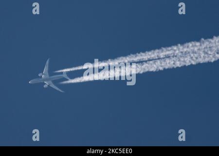 All Nippon Airways Boeing 787 Dreamliner aircraft as seen flying to Paris CDG airport in France in the blue sky over Europe at 40.000 feet leaving the chemtrails or contrails behind, a vapor condensation formation when seen as a white line behind the overfly airplane. The newly made modern and advanced in technology vehicle, built in March 2020 in the USA, long haul overflying airplane is a Boeing 787-9 Dreamliner passenger plane with the registration JA928A, powered by 2x RR jet engines. ALL NIPPON ANA NH also known as Zennikk? ( ??? in Japanese ) is the largest airline in Japan with Hub base Stock Photo