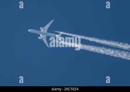 All Nippon Airways Boeing 787 Dreamliner aircraft as seen flying to Paris CDG airport in France in the blue sky over Europe at 40.000 feet leaving the chemtrails or contrails behind, a vapor condensation formation when seen as a white line behind the overfly airplane. The newly made modern and advanced in technology vehicle, built in March 2020 in the USA, long haul overflying airplane is a Boeing 787-9 Dreamliner passenger plane with the registration JA928A, powered by 2x RR jet engines. ALL NIPPON ANA NH also known as Zennikk? ( ??? in Japanese ) is the largest airline in Japan with Hub base Stock Photo