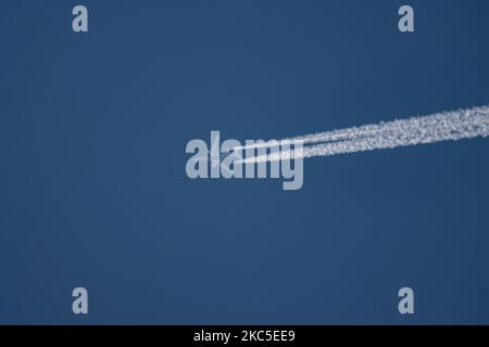 All Nippon Airways Boeing 787 Dreamliner aircraft as seen flying to Paris CDG airport in France in the blue sky over Europe at 40.000 feet leaving the chemtrails or contrails behind, a vapor condensation formation when seen as a white line behind the overfly airplane. The newly made modern and advanced in technology vehicle, built in March 2020 in the USA, long haul overflying airplane is a Boeing 787-9 Dreamliner passenger plane with the registration JA928A, powered by 2x RR jet engines. ALL NIPPON ANA NH also known as Zennikk? ( ??? in Japanese ) is the largest airline in Japan with Hub base Stock Photo