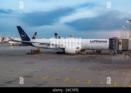 Lufthansa Airbus A350 aircraft as seen early morning in the dawn, sunrise and during the day parked at the gates of Munich International Airport EDDM MUC. The wide-body modern and advanced A359 or A350-900 passenger plane has the registration D-AIXO, the name Ulm and is powered by 2x RR jet engines. Deutsche Lufthansa AG DLH or LH is the largest airline in Germany with hub base in Frankfurt, Munich and Berlin airport, former German flag carrier and founding member of Star Alliance airline aviation group. The world passenger traffic declined during the coronavirus covid-19 pandemic era with the Stock Photo