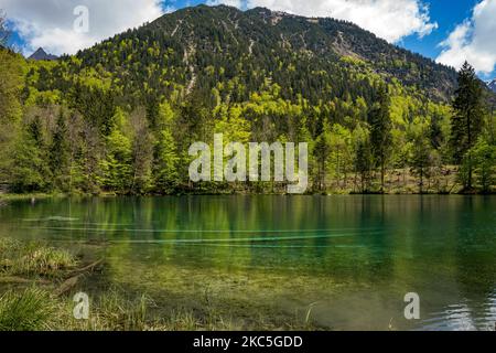 A wonderful landscape of the turquoise lake Christlessee against a mountain covered by trees Stock Photo