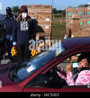 A woman waits for food assistance to be placed in her car at the Share Your Christmas food distribution event sponsored by the Second Harvest Food Bank of Central Florida, Faith Neighborhood Center, and WESH 2 at Hope International Church on December 9, 2020 in Groveland, Florida, near Orlando. Central Florida food banks struggle to serve those facing food insecurity during the holiday season amid the COVID-19 pandemic. (Photo by Paul Hennessy/NurPhoto) Stock Photo