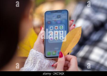 Kyiv, Ukraine - November 4, 2022. Microsoft 365 applications are visible on an iPhone held by a girl in the background - Office, Word, Excel, PowerPoi Stock Photo