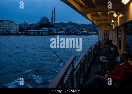 A ferry in Istanbul, Turkey on December 11, 2020. As part of the measures against the spread of COVID-19, Turkish government ordered all restaurants and cafes to switch to takeaway and delivery service. People mostly socialize and spend their free time at the seasides. (Photo by Erhan Demirtas/NurPhoto) Stock Photo