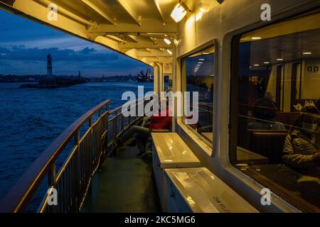A ferry in Istanbul, Turkey seen on December 11, 2020. As part of the measures against the spread of COVID-19, Turkish government ordered all restaurants and cafes to switch to takeaway and delivery service. People mostly socialize and spend their free time at the seasides. (Photo by Erhan Demirtas/NurPhoto) Stock Photo