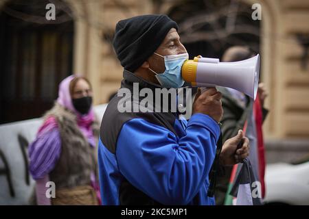 A protester wearing face mask speaks trough a megaphone during a demonstration in support of the Sahrawi people's rights in Granada on December 12, 2020. Cities throughout Spain have demonstrated in favor to self-determination in Western Sahara and denounce the violation of the 1991 ceasefire agreements last week. This has triggered the resumption of the armed conflict between the Moroccan army and the Polisario Front. (Photo by Fermin Rodriguez/NurPhoto) Stock Photo