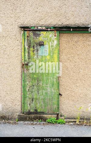 Building entrance with green sliding door Stock Photo
