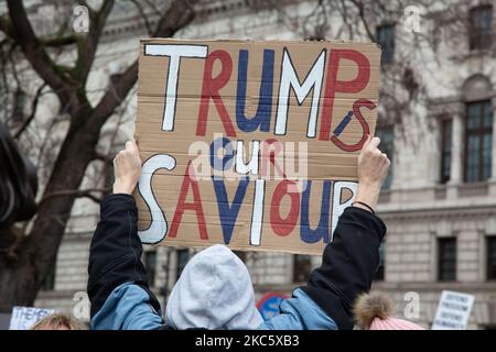 A Donald Trump supporter holds a placard at an anti-vaccination protest in Parliament Square, in London, United Kingdom, on December 14, 2020. (Photo by Kiki Streitberger/NurPhoto) Stock Photo
