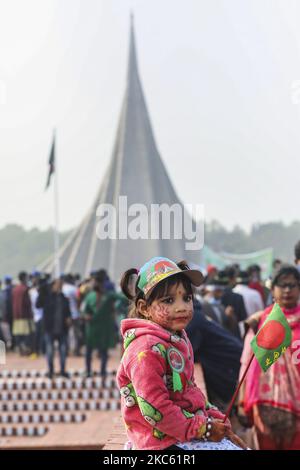 A girl with psinted national mirtyre monument on her cheek as people gather to pay their respect at the national memorial of the 1971 Bangladesh independence war's martyrs to mark the country's Victory Day in Savar on December 16, 2020. Bangladesh celebrated its 50th victory day with due solemnity and rich tributes paid to the martyrs of the Liberation War of 1971. (Photo by Ahmed Salahuddin/NurPhoto) Stock Photo