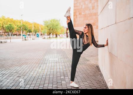 Young woman in black suit taking selfie on street Stock Photo