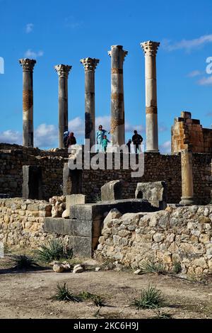 Tourists amongst the ruins of the ancient Roman town of Volubilis in Meknes, Morocco, Africa. Volubilis is a partly excavated Roman city built in the 3rd century BC onwards as a Phoenician (and later Carthaginian) settlement. The site was excavated and revealed many fine mosaics, including some of the more prominent public buildings and high-status houses were restored or reconstructed. Today it is a UNESCO World Heritage Site , listed for being 'an exceptionally well preserved example of a large Roman colonial town on the fringes of the Empire'. (Photo by Creative Touch Imaging Ltd./NurPhoto) Stock Photo