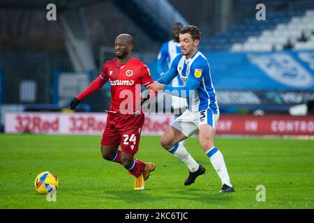 Sone Aluko of Reading battles with Harry Toffolo of Huddersfield Townduring the Sky Bet Championship match between Huddersfield Town and Reading at the John Smith's Stadium, Huddersfield on Saturday 2nd January 2021. (Photo by Pat Scaasi/MI News/NurPhoto) Stock Photo