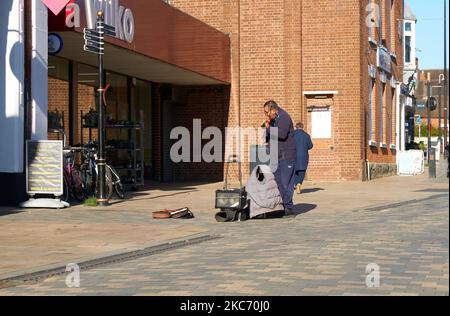 Busker on a deserted high street in Uttoxeter, Staffordshire, UK Stock Photo