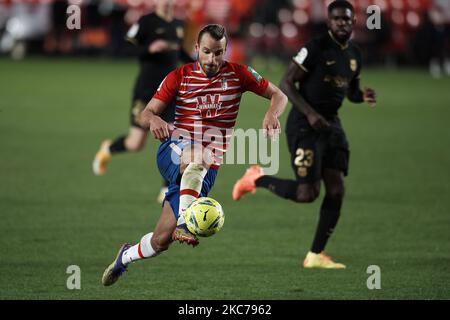 Roberto Soldado of Granada runs with the ball during the La Liga Santander match between Granada CF and FC Barcelona at Estadio Nuevo Los Carmenes on January 9, 2021 in Granada, Spain. Sporting stadiums around Spain remain under strict restrictions due to the Coronavirus Pandemic as Government social distancing laws prohibit fans inside venues resulting in games being played behind closed doors. (Photo by Jose Breton/Pics Action/NurPhoto) Stock Photo
