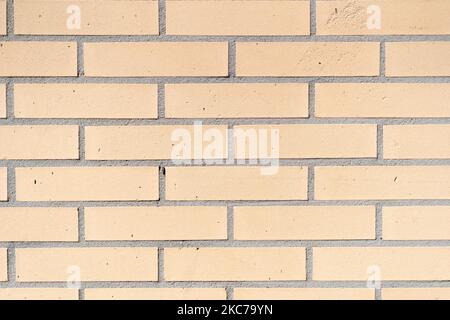 A closeup shot of a cream white brick wall, perfect for backgrounds and wallpapers Stock Photo