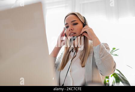 Young woman working in call center. Customer support woman in office Stock Photo