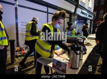 A group of volunteers from the Homeless Mobile Run distributing hot meals, drinks, treats, clothes and toiletries to people in need, outside Dunnes Stores on Grafton Street, Dublin, during Level 5 Covid-19 lockdown. On Wednesday, 20 January, 2021, in Dublin, Ireland. (Photo by Artur Widak/NurPhoto) Stock Photo